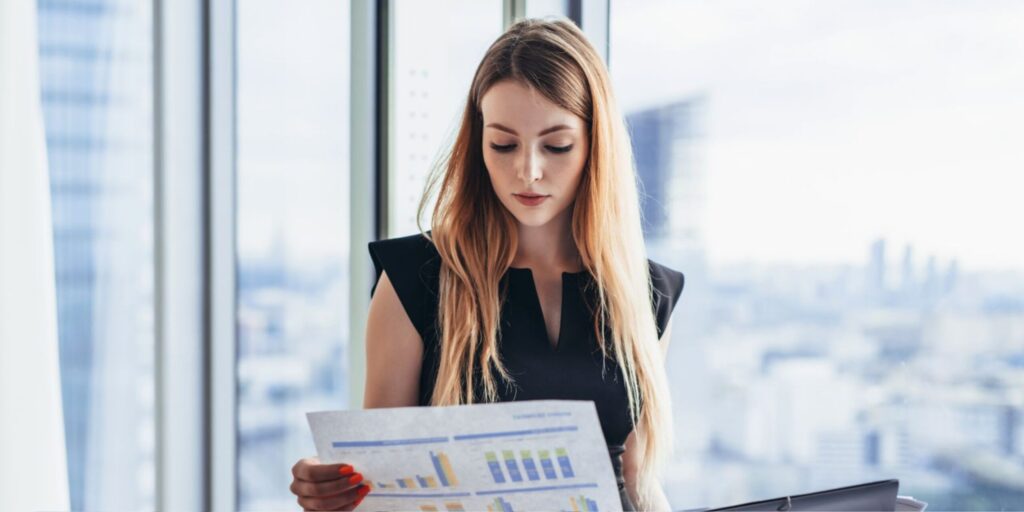 Female tax analyst reviewing risk data charts